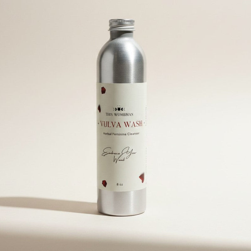 Silver bottle labeled 'Vulva Wash' on a beige background